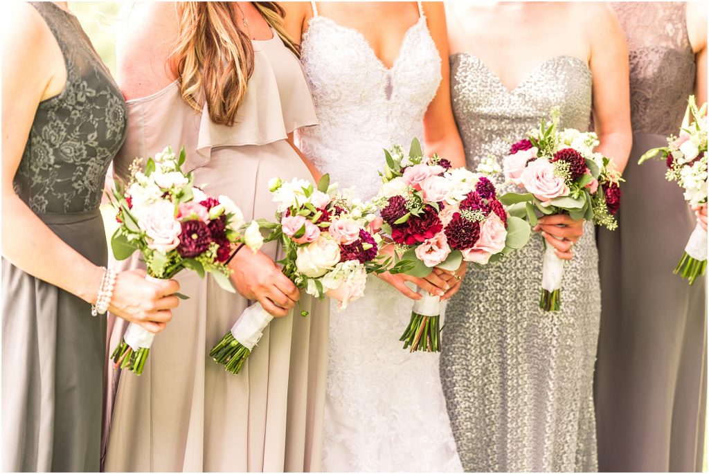 Bride and bridesmaids holding bouquets bridesmaid dresses