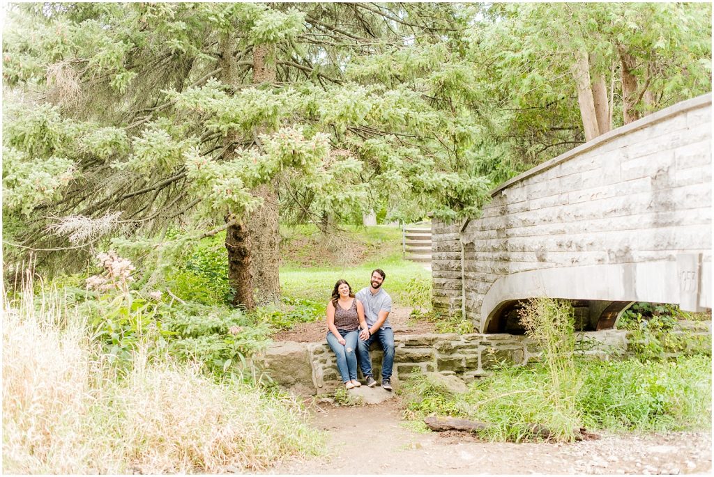 Spencer Gorge Engagement Session couple sitting at the Grand River bank