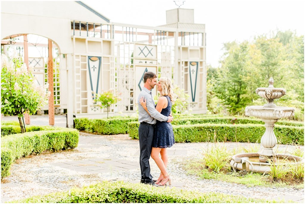 whistling gardens engagement session fiance couple snuggling