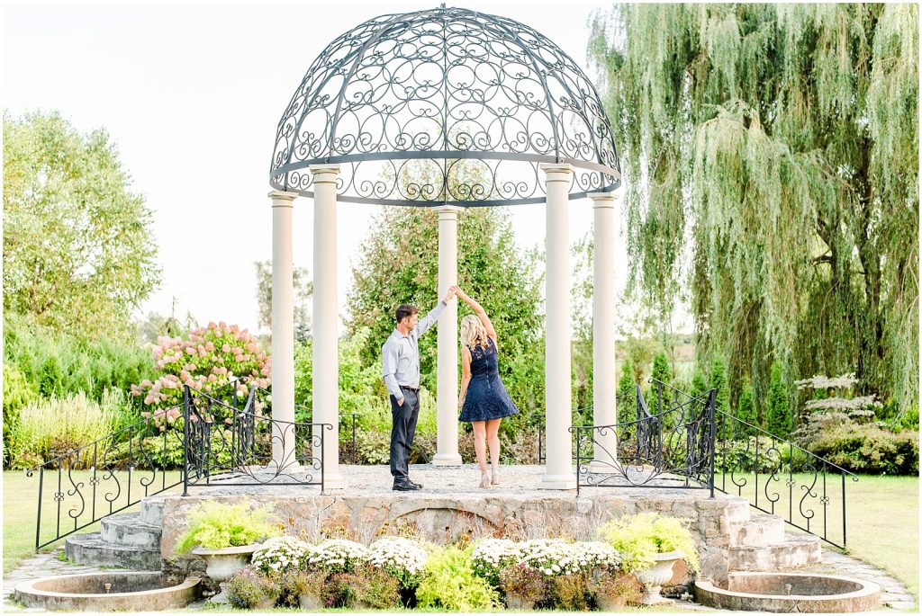 whistling gardens engagement session fiance couple twirling dancing