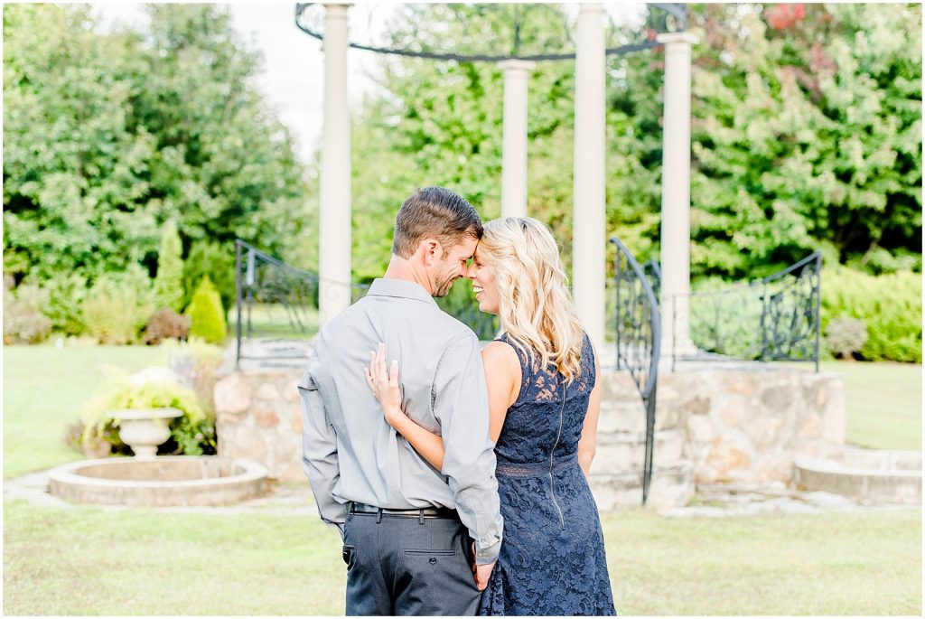 whistling gardens engagement session fiance couple snuggling