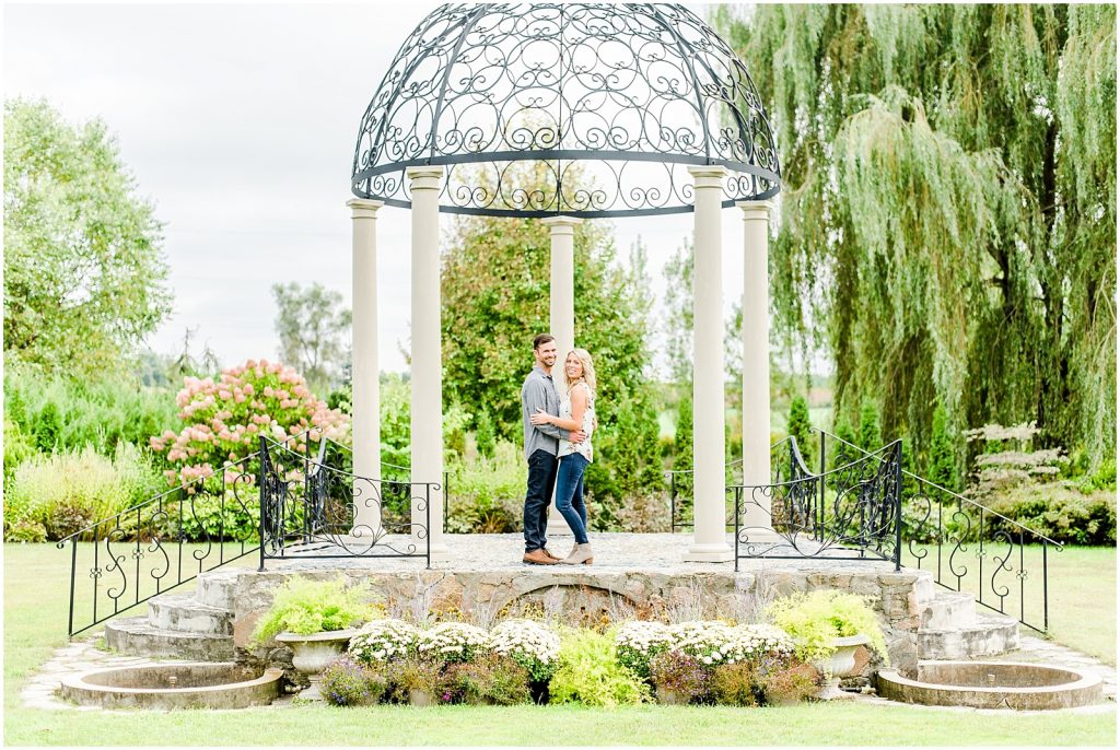 whistling gardens engagement session fiance couple snuggling kissing