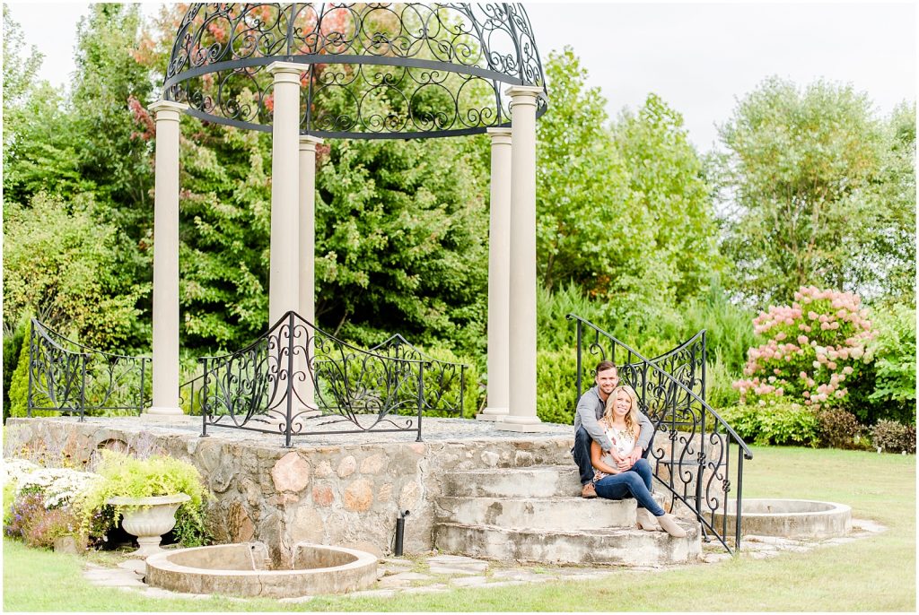 whistling gardens engagement session fiance couple sitting