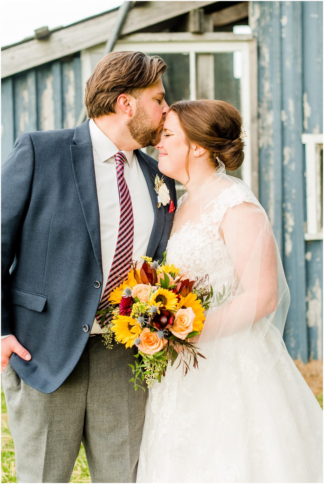 St. Mary's Countryside Wedding groom kisses bride's forehead