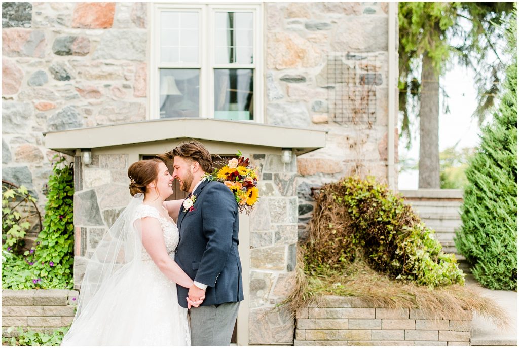 St. Mary's Countryside Wedding bride and groom in front of stone house