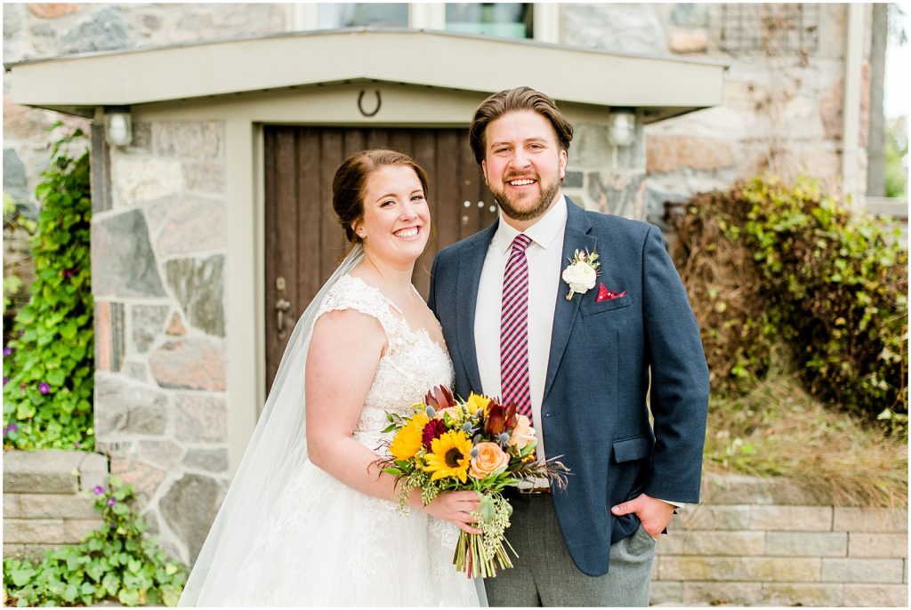 St. Mary's Countryside Wedding bride and groom in front of stone house