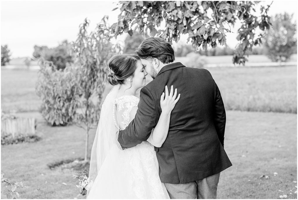 St. Mary's Countryside Wedding black and white of bride and groom in front of apple tree