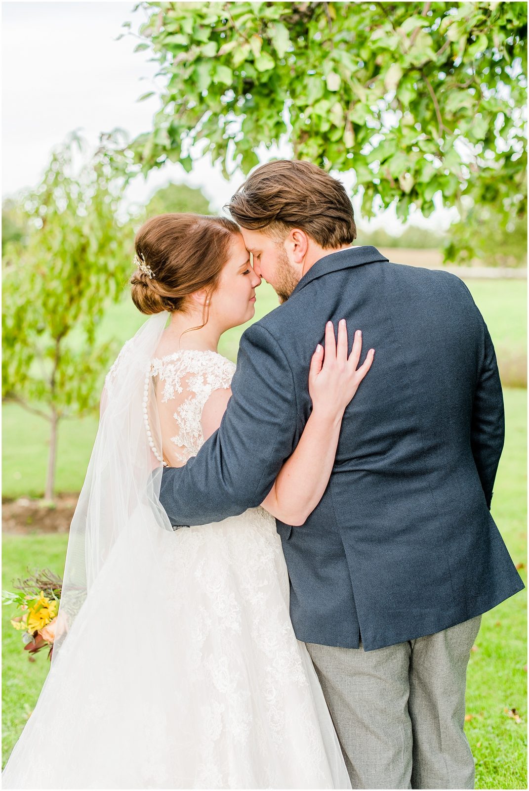 St. Mary's Countryside Wedding bride and groom in front of apple tree