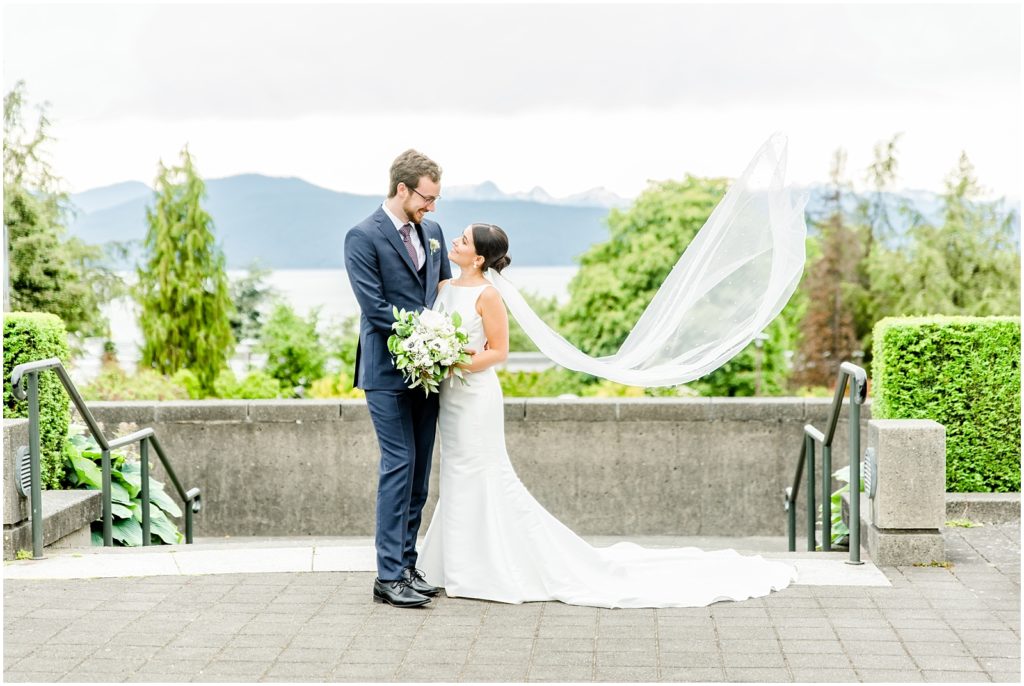 Burnaby Vancouver Wedding Bride and Groom looking at each other at the UBC Rose Garden with veil flowing in the wind