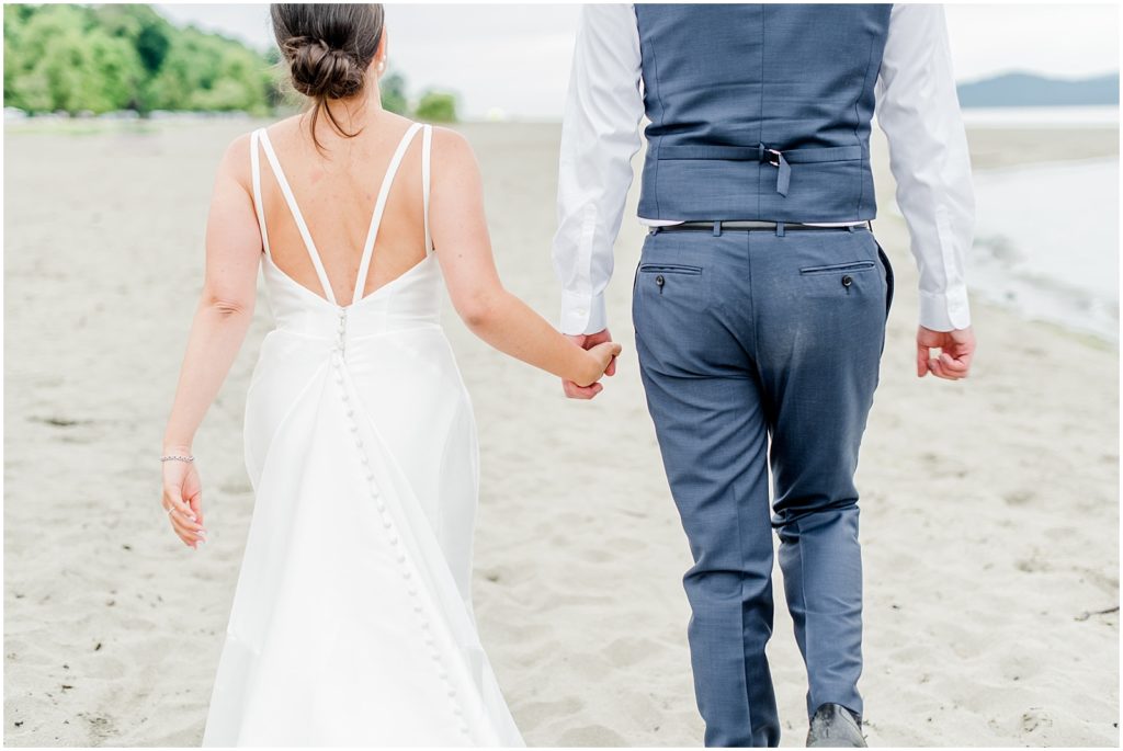 Burnaby Vancouver Wedding Bride and Groom holding hands at Spanish Banks