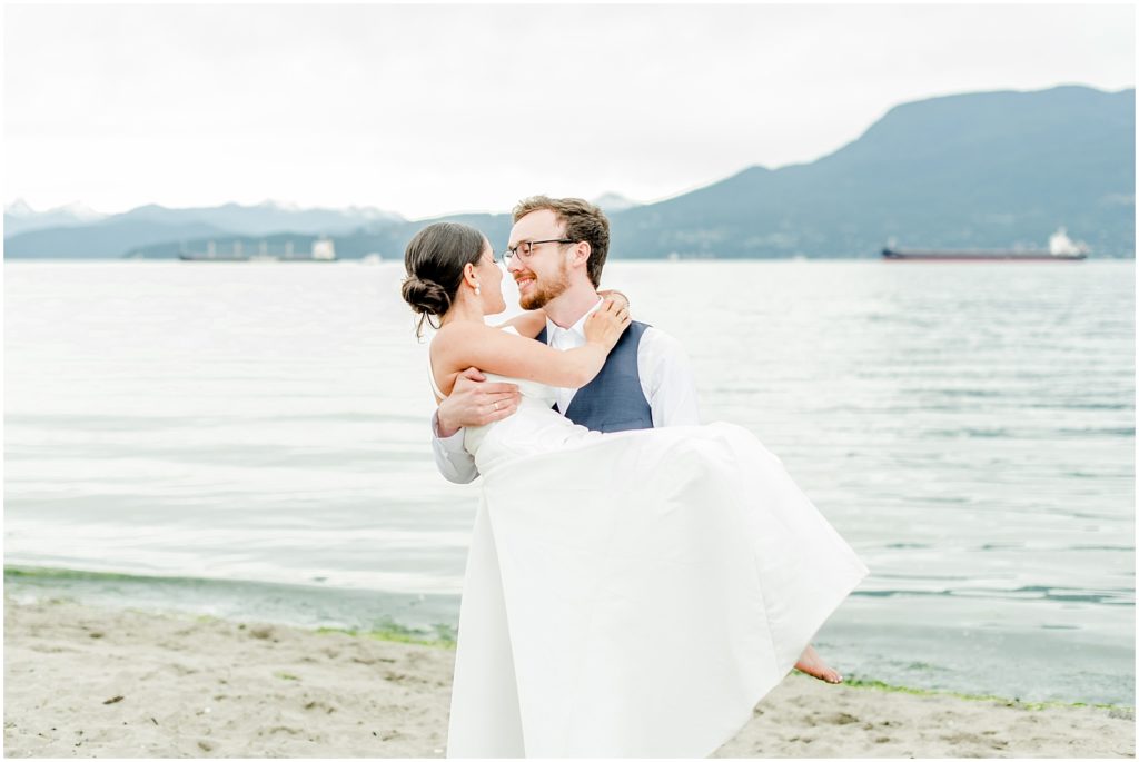 Burnaby Vancouver Wedding Groom spinning Bride at Spanish Banks