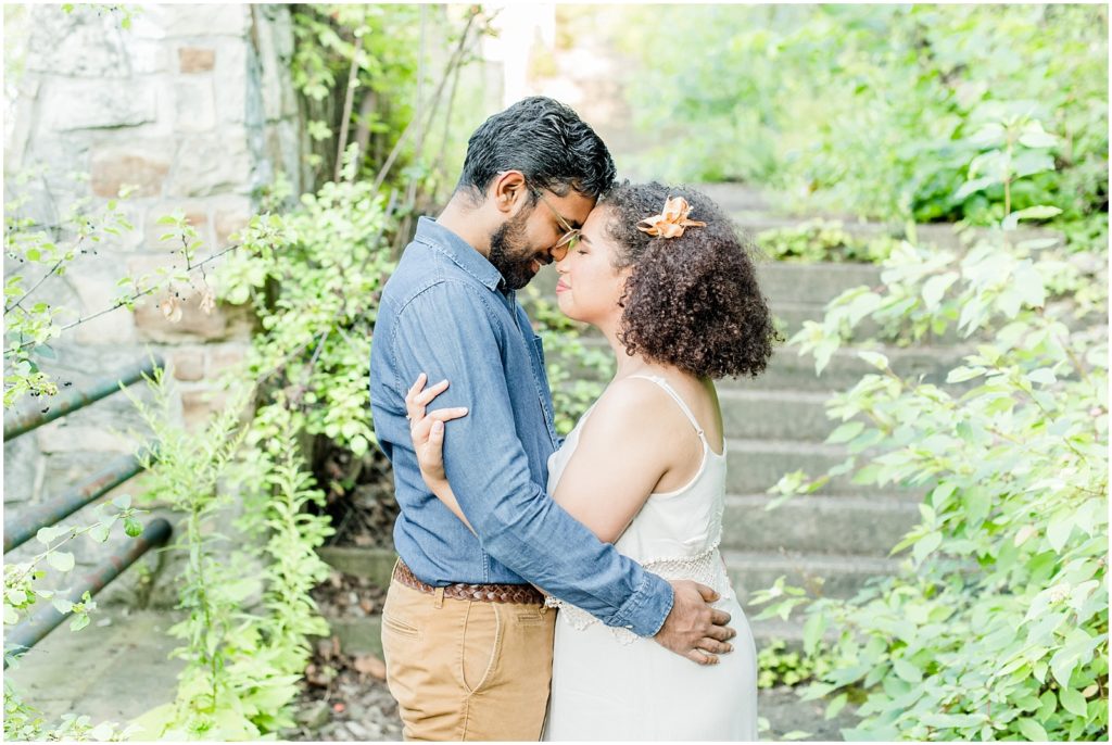 Sam Lawrence Park Hamilton Engagement Session couple nuzzling in front of steps on overgrown path