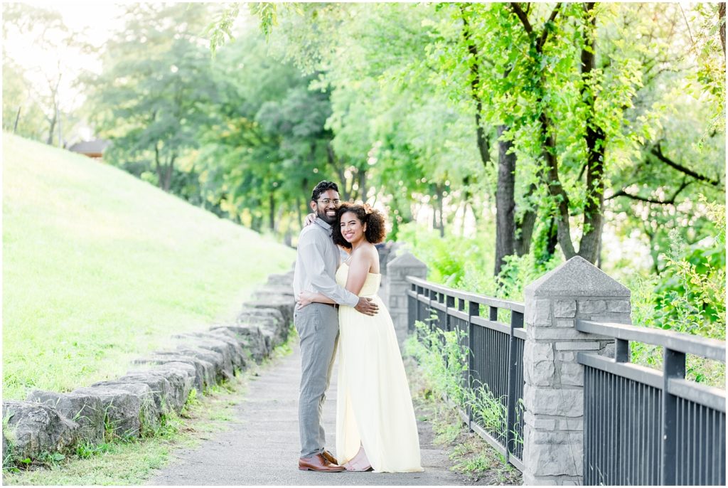 Sam Lawrence Park Hamilton Engagement Session couple smiling on pathway under beautiful trees