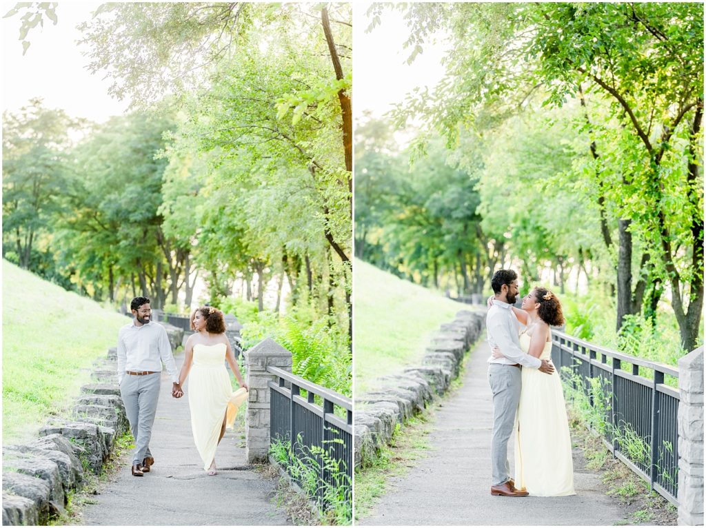 Sam Lawrence Park Hamilton Engagement Session couple walking and hugging on pathway under beautiful trees