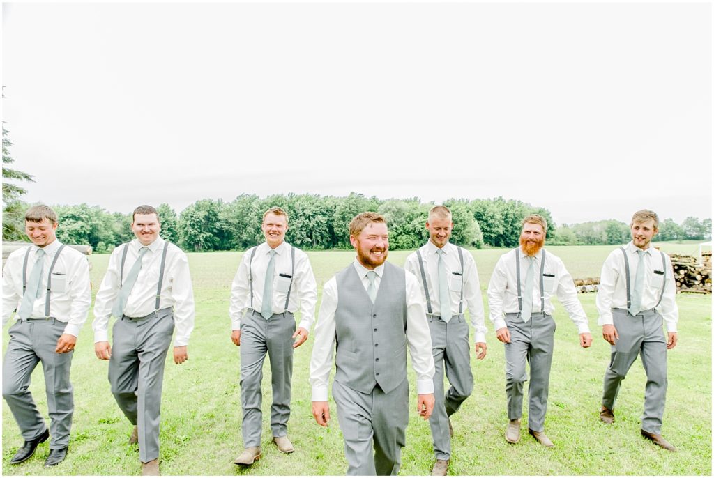 Princeton backyard wedding groom and groomsmen walking in field