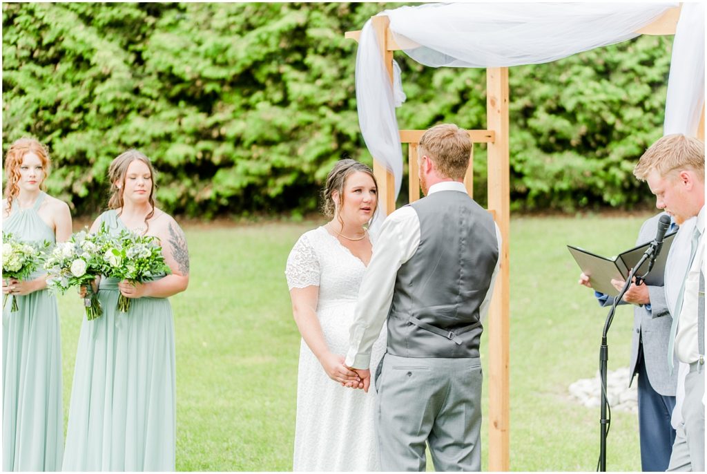 Princeton backyard wedding bride looking at groom at ceremony