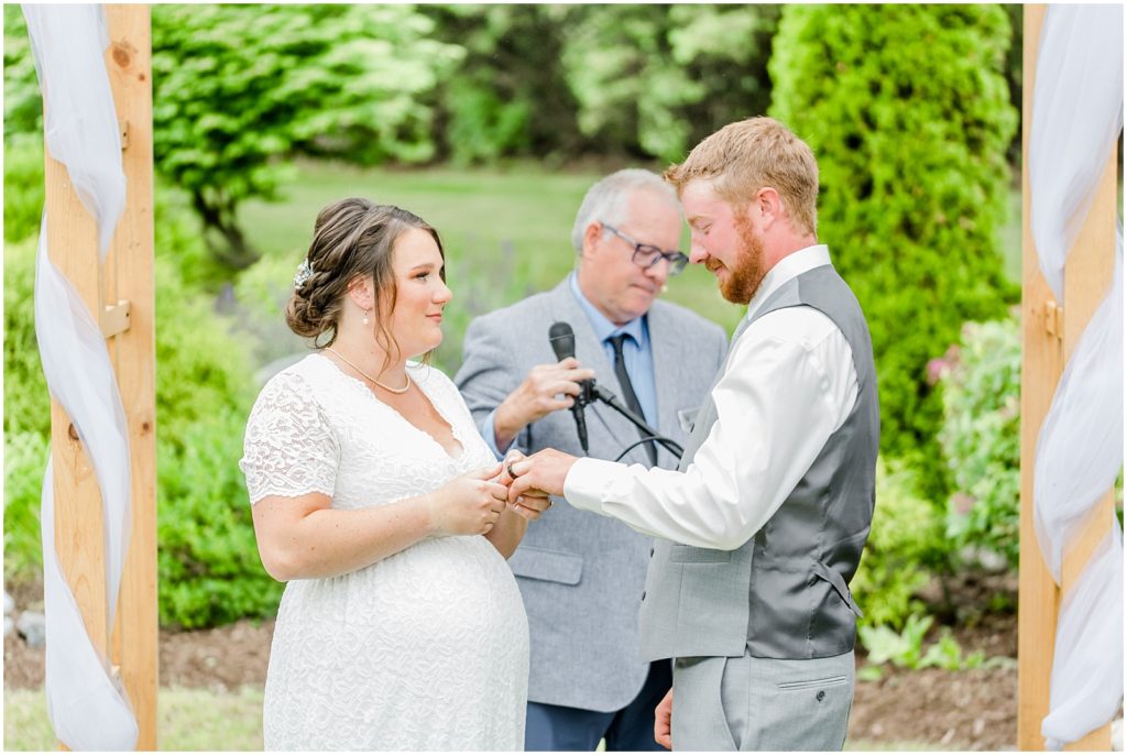 Princeton backyard wedding bride and groom exchange rings