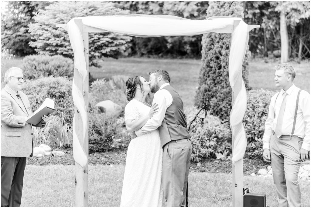 Princeton backyard wedding bride and groom's first kiss