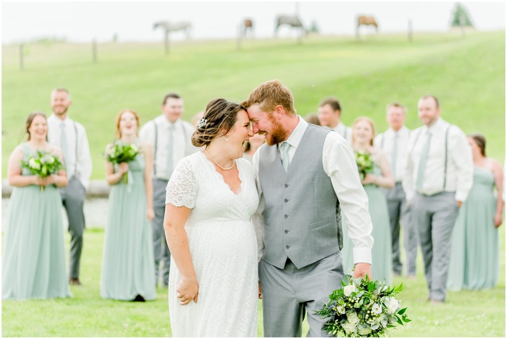 Princeton backyard wedding bride and groom walking in front of wedding party in horse field