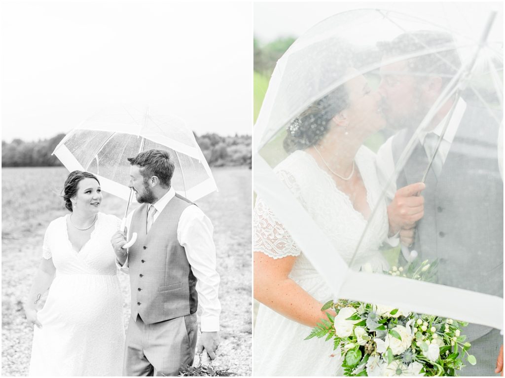 Princeton backyard wedding bride and groom laughing and kissing under a clear umbrella in the rain