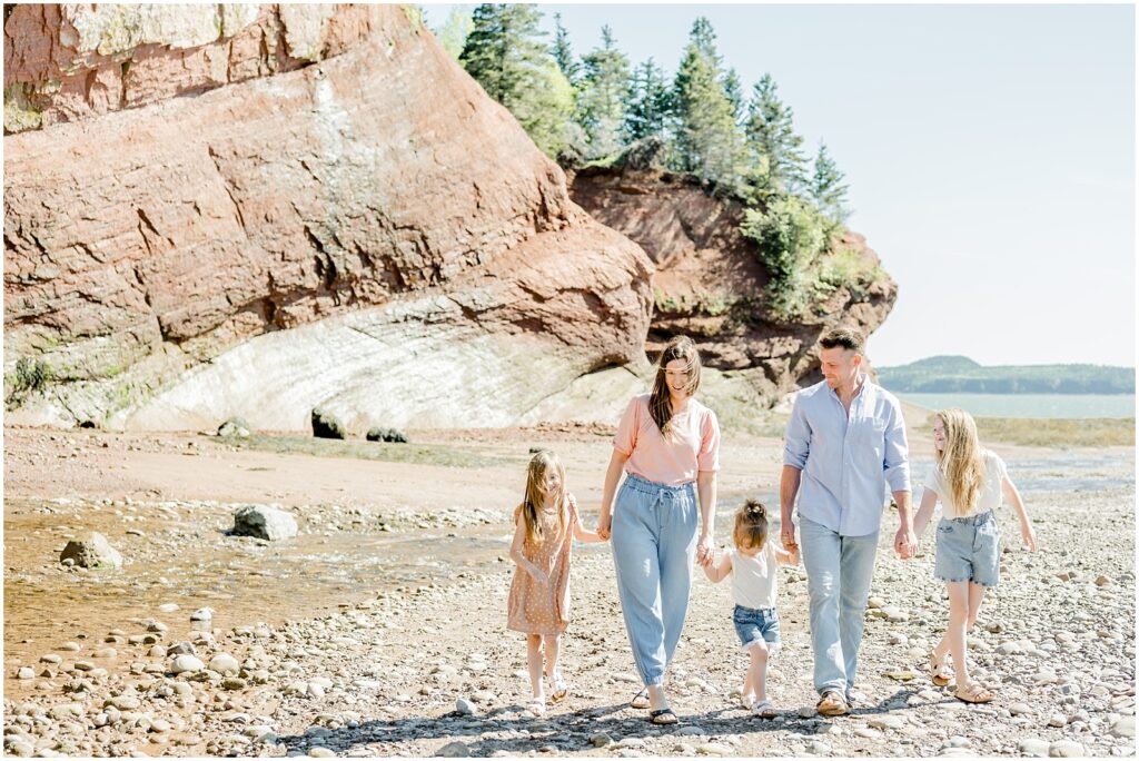 Saint Martins Portrait Session family holding hands smiling walking in the sand