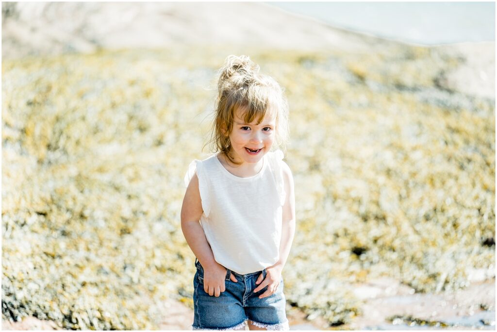 Saint Martins Portrait Session little girl standing and smiling on the shore