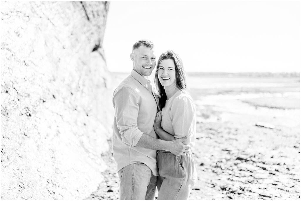 Saint Martins Portrait Session black and white photo of husband and wife smiling holding each other close