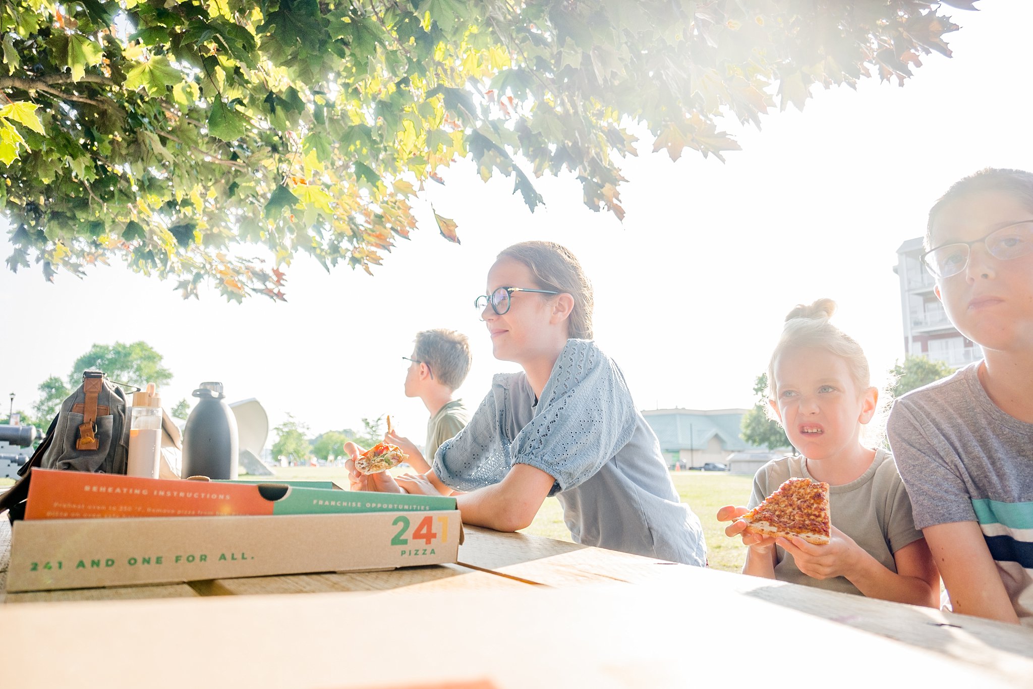 family traveling eating pizza