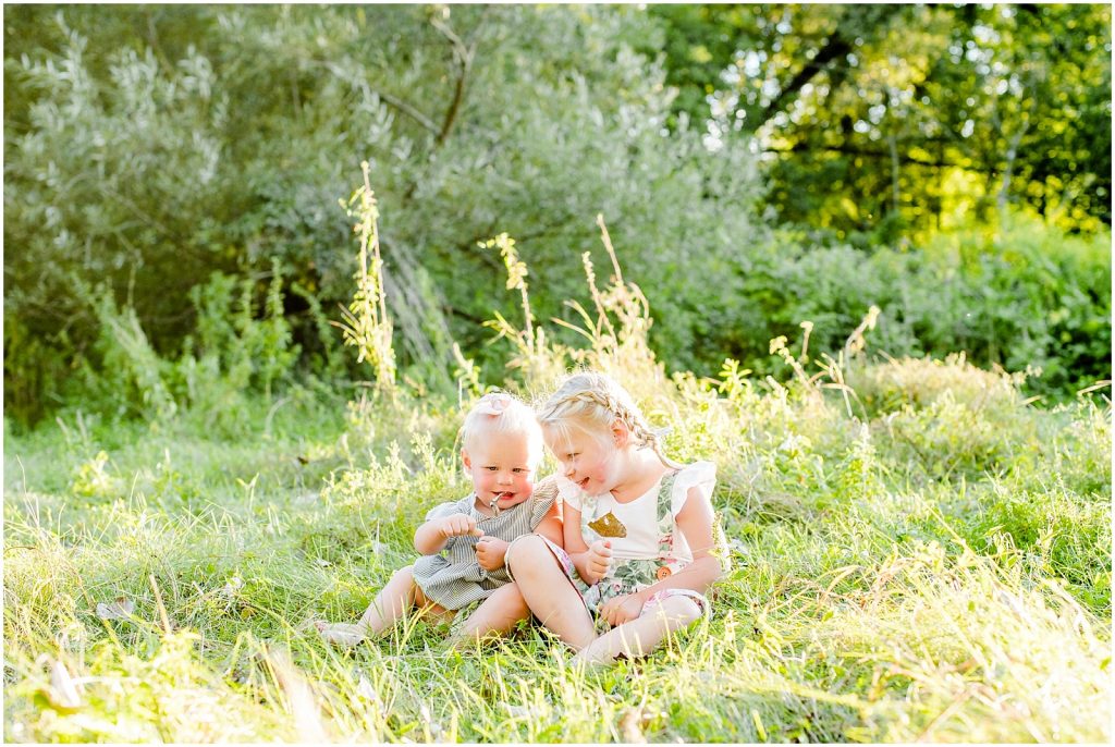 grand river bank brant conservation brantford family session sisters talking in grass