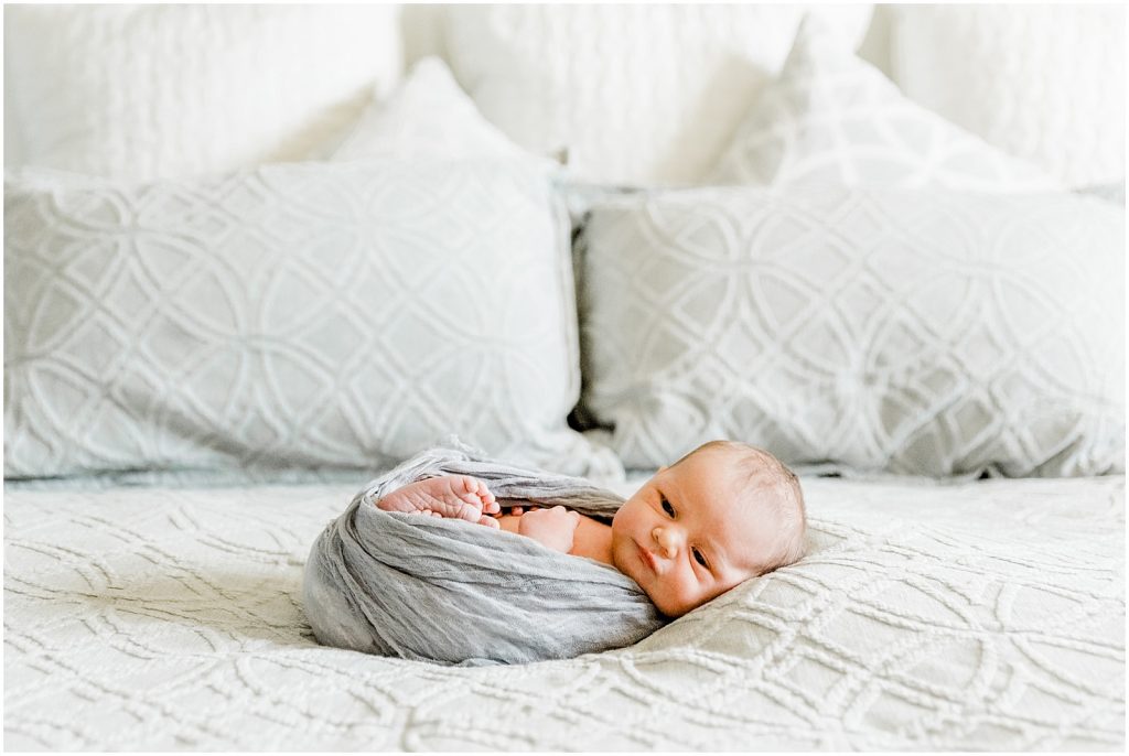 ancaster hamilton lifestyle newborn session baby in wrap on bed