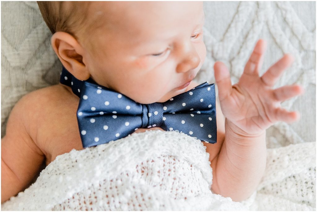 ancaster hamilton lifestyle newborn session baby wearing bowtie on bed