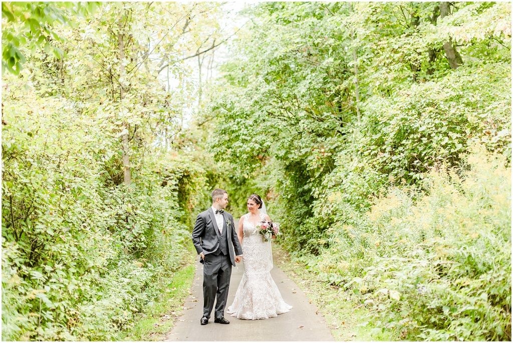firerock golf course wedding bride and groom walking on path in between trees