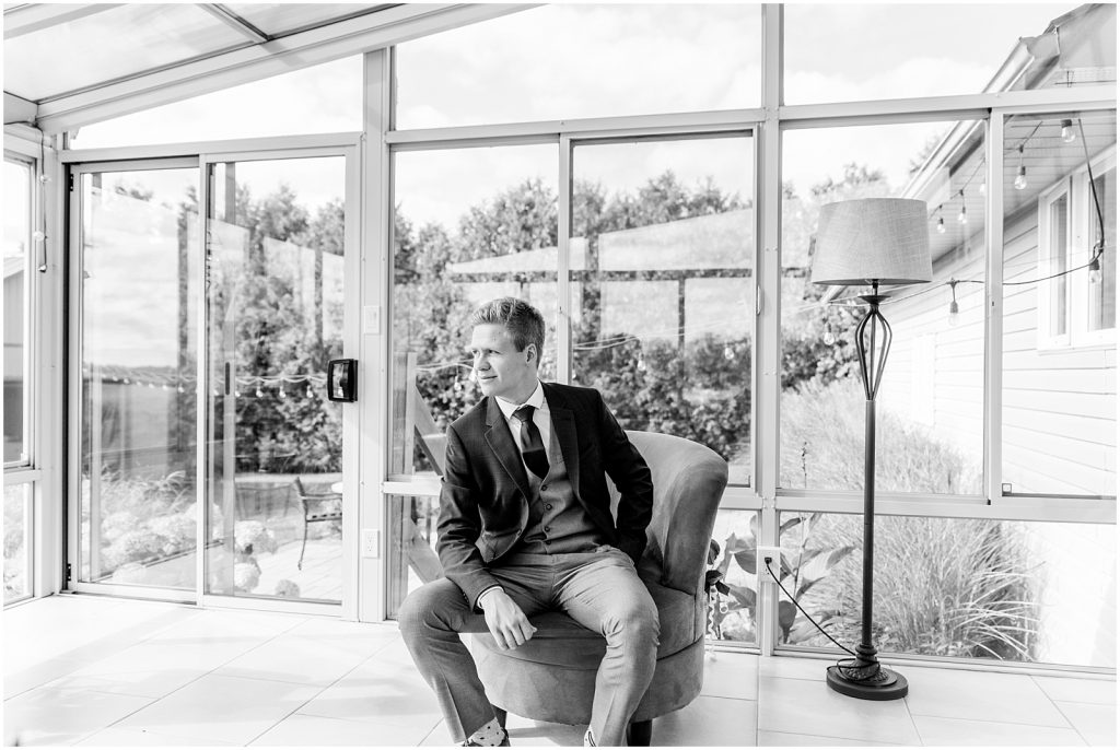 oxford country countryside wedding groom sitting on chair in sunroom