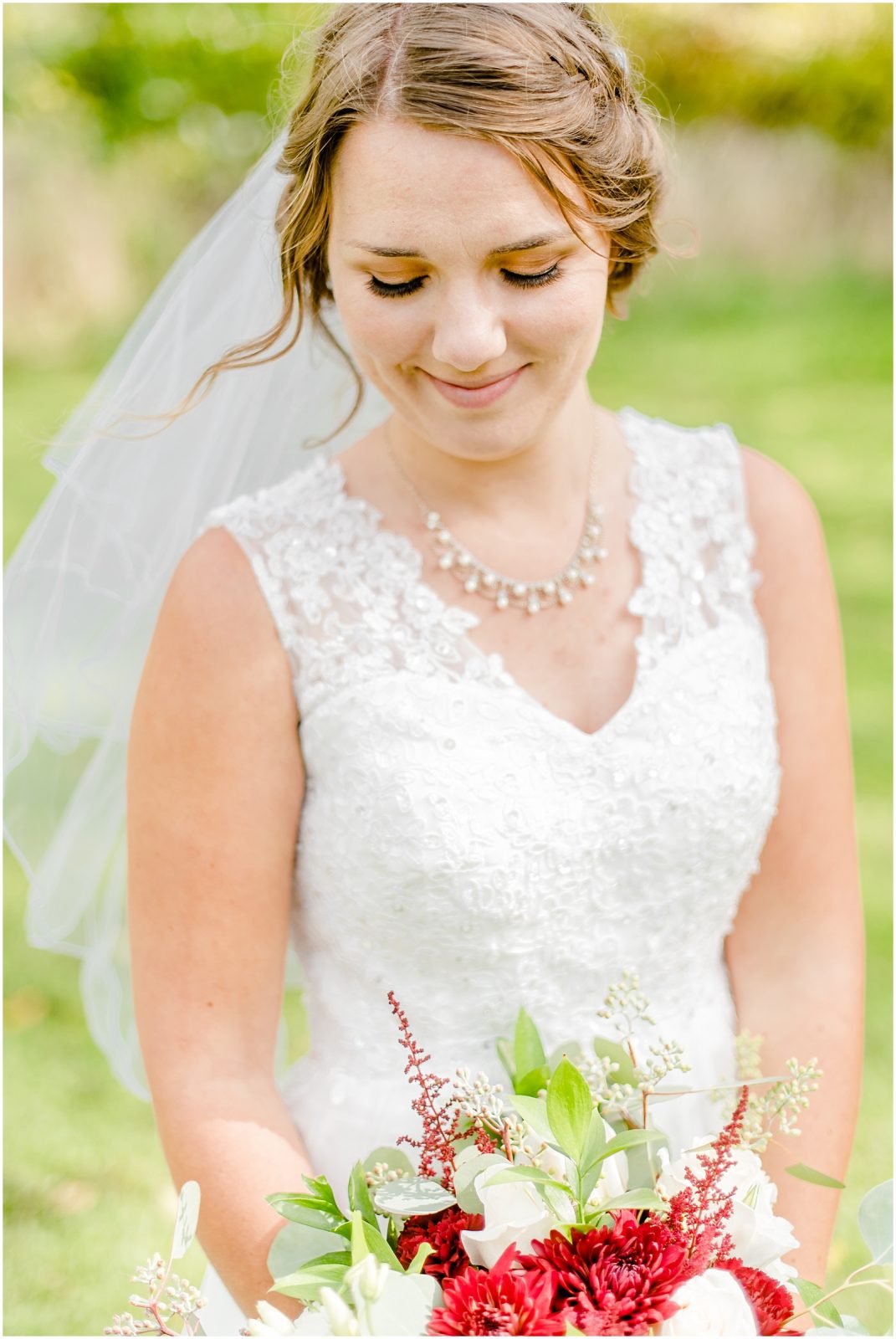oxford country countryside wedding bride smiling down at bouquet
