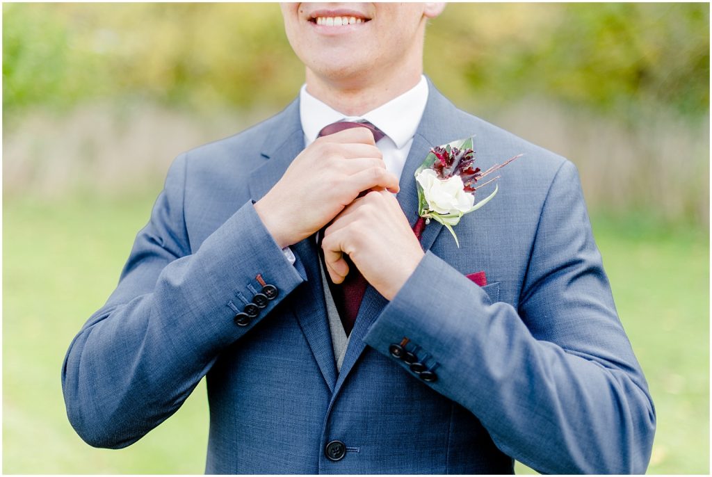 oxford country countryside wedding groom adjusting necktie