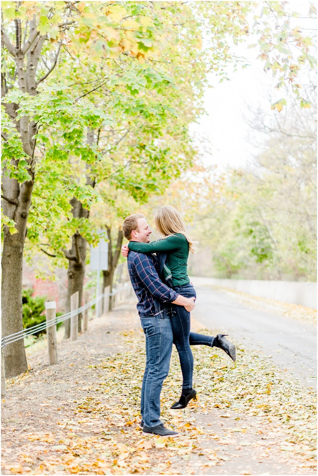 Lorne Park Brantford Engagement Session couple kissing in the fall leaves