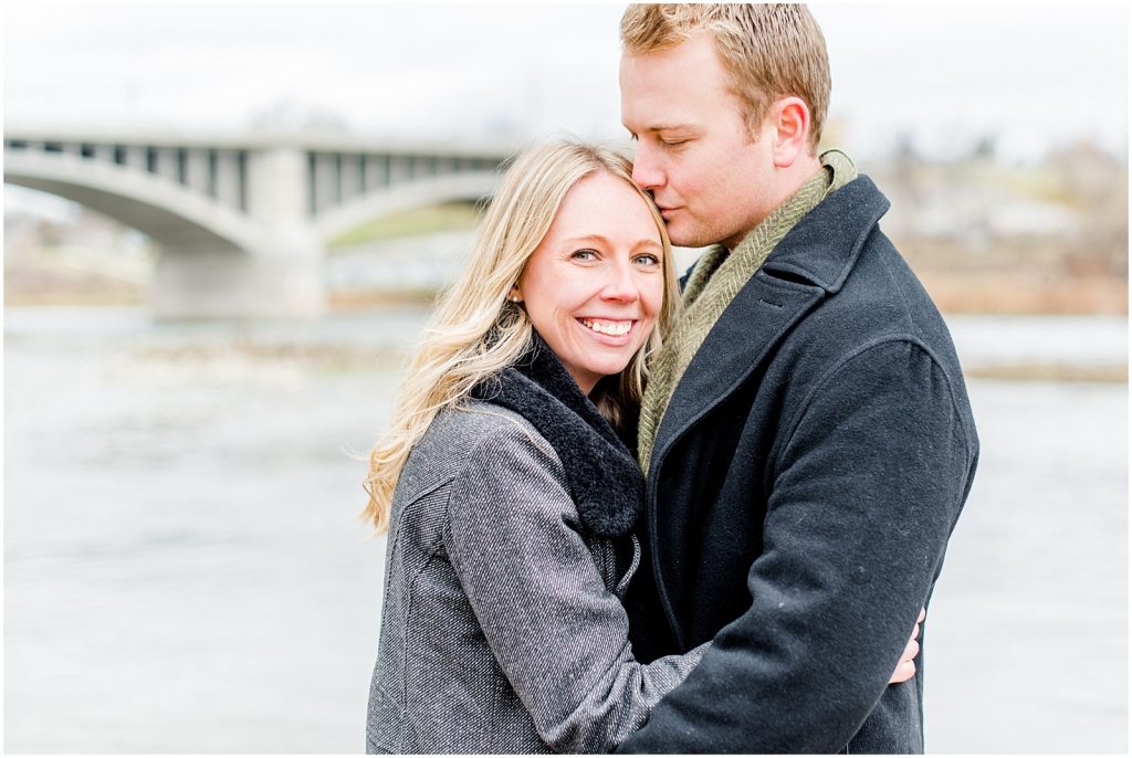 Lorne Park Brantford Engagement Session couple hugging by the Grand River