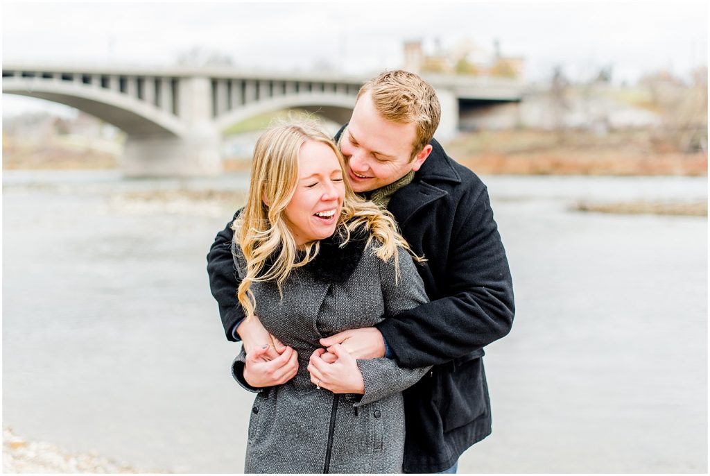 Lorne Park Brantford Engagement Session couple laughing by the Grand River