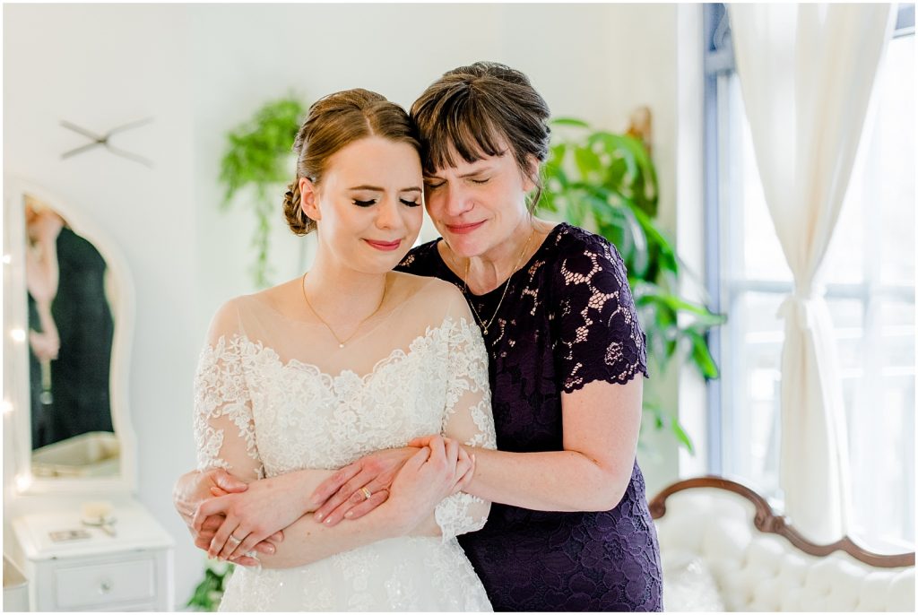 primp and proper salon vancouver wedding mom hugging bride in dress