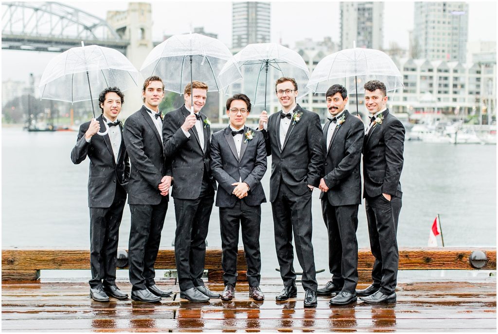 burnaby vancouver wedding groom and groomsmen holding umbrellas at Granville Island