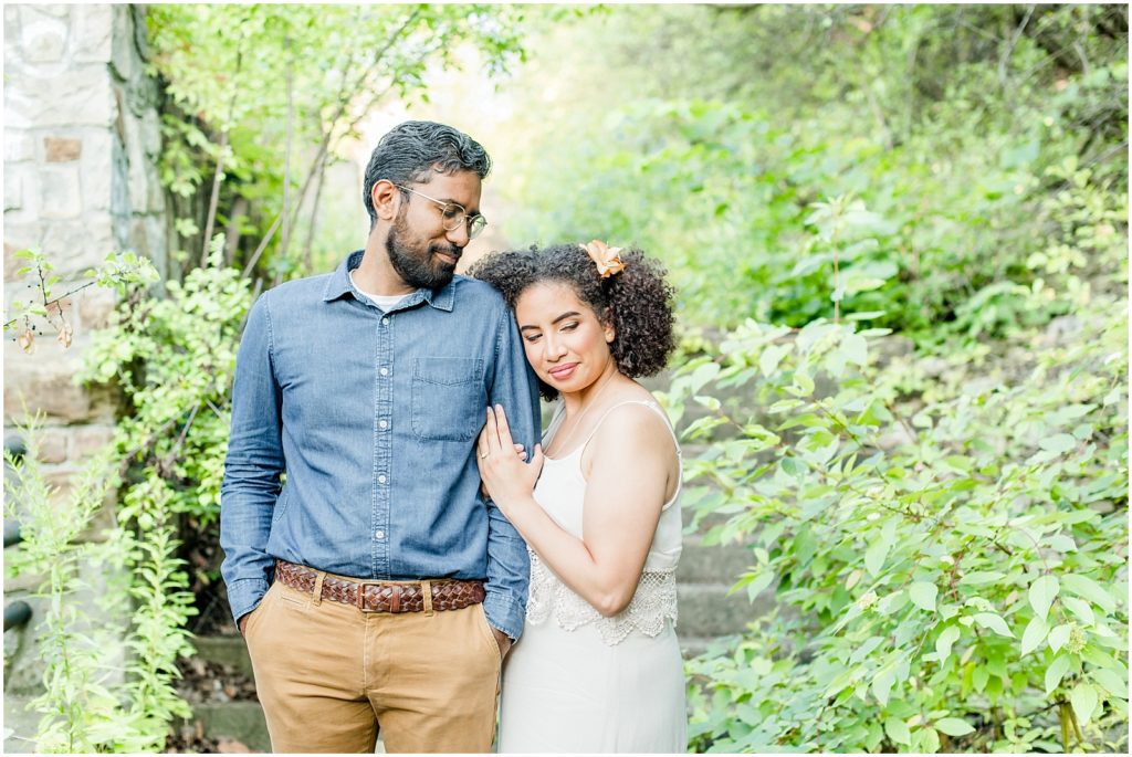 Sam Lawrence Park Hamilton Engagement Session couple snuggling on overgrown pathway