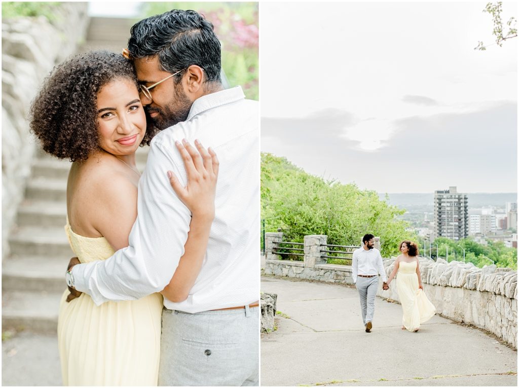 Sam Lawrence Park Hamilton Engagement Session couple walking on pathway with city views and hugging and front of steps